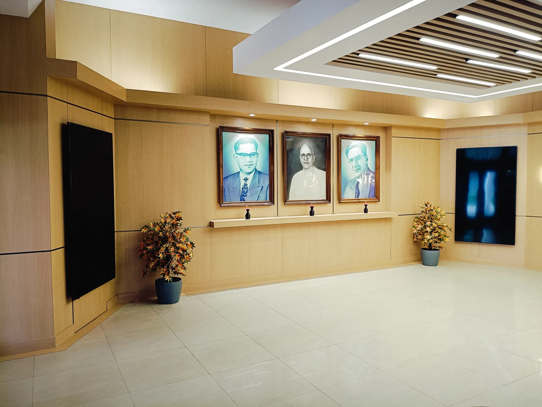 Portrait display on a pale timber-finish wall