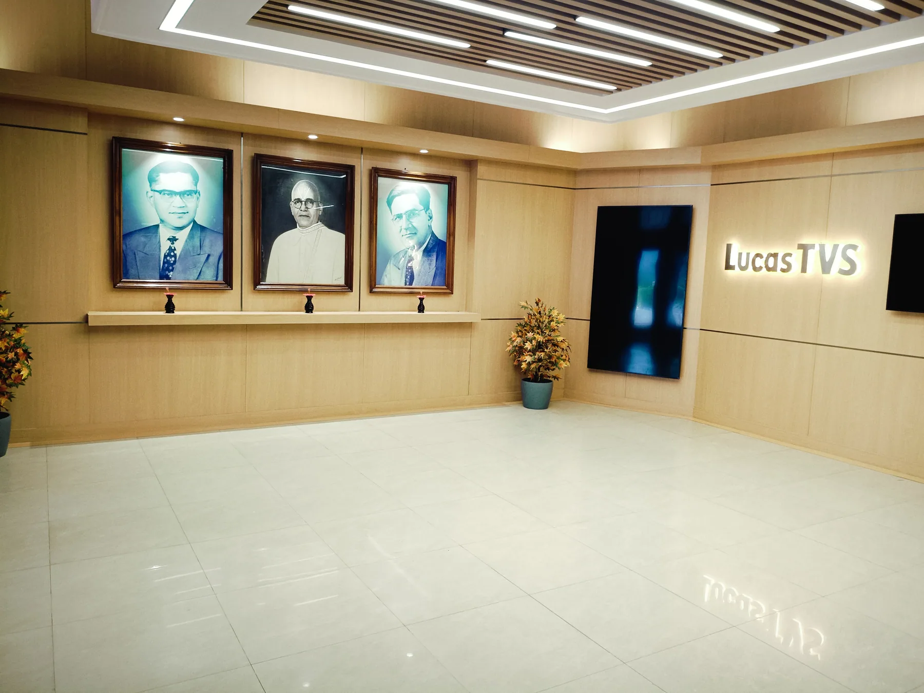 Portrait wall beside illuminated branding