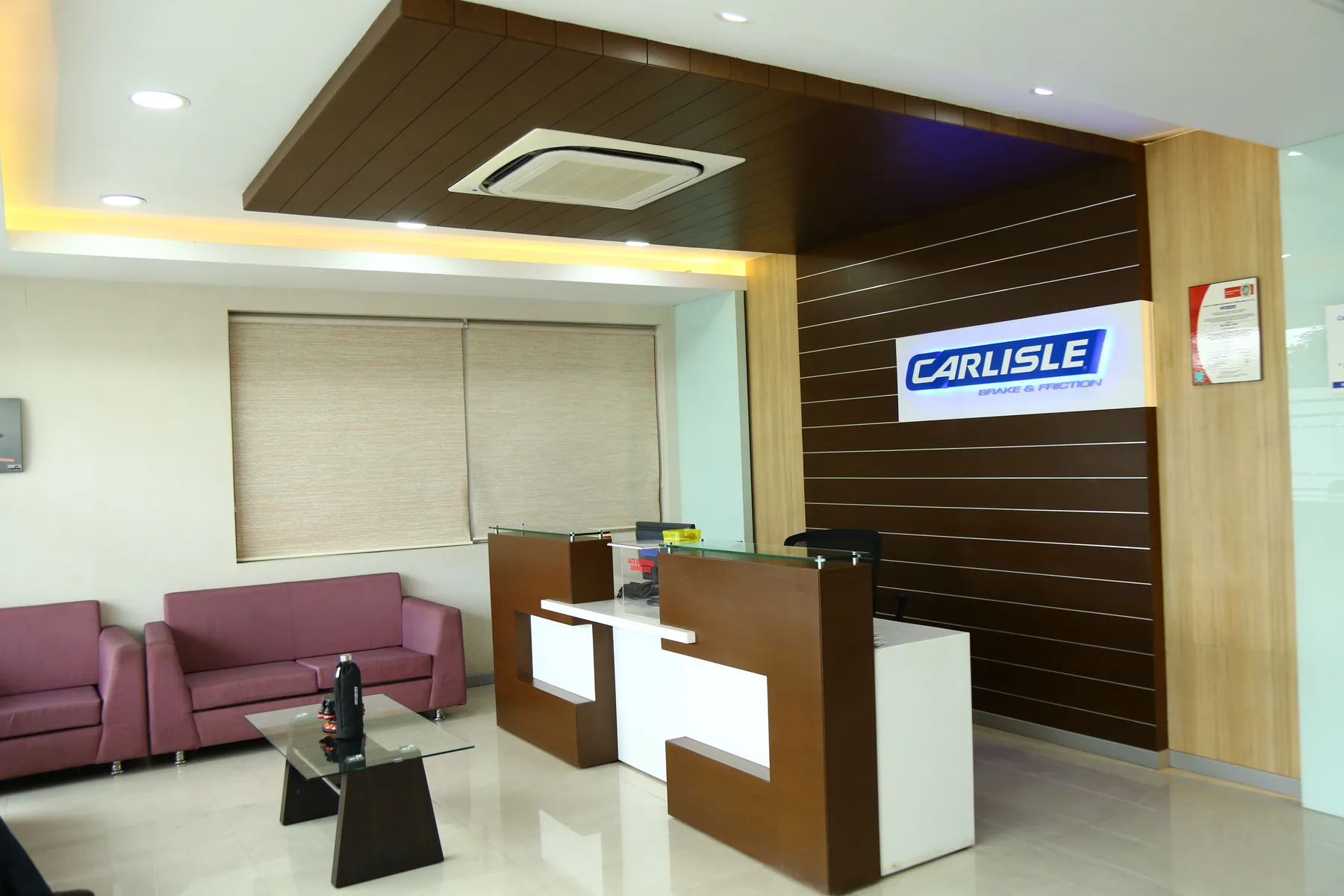 Office reception with a timber feature wall, fitted desk and visitor seating
