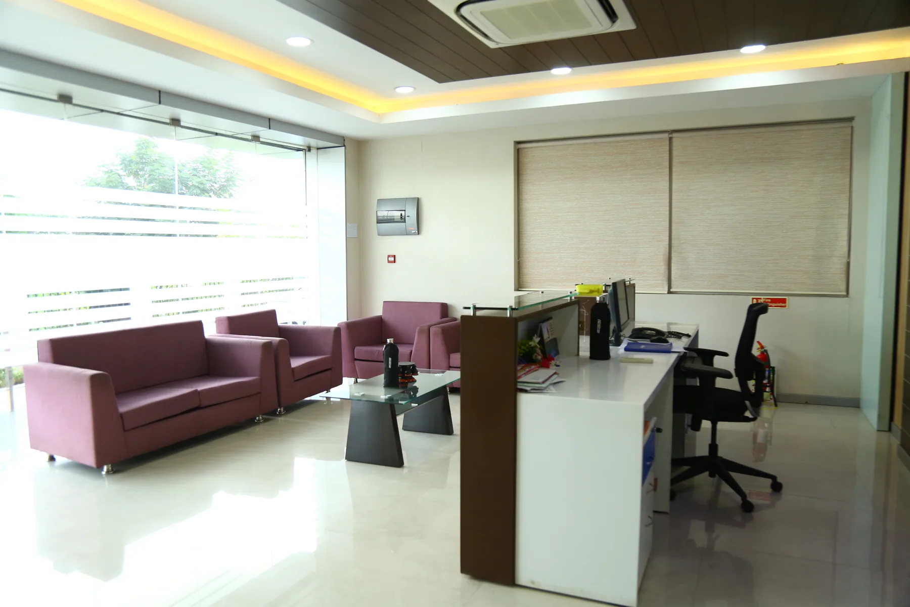Private office with a desk, visitor seating and fitted wall panels