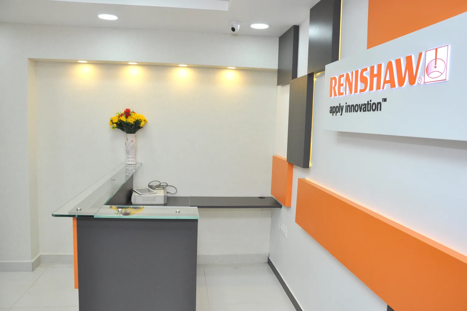 Side view of the reception desk and orange feature wall