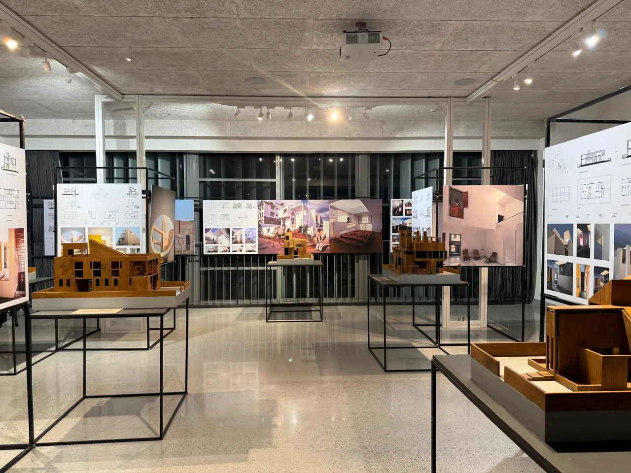 Architectural models on slim metal tables with illustrated display panels